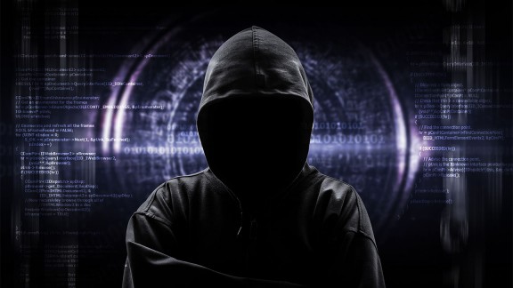 Dark photo of a hacker in a hoodie