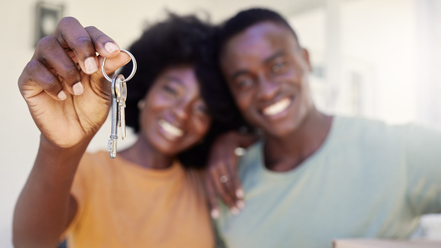 Couple with keys to a new home.
